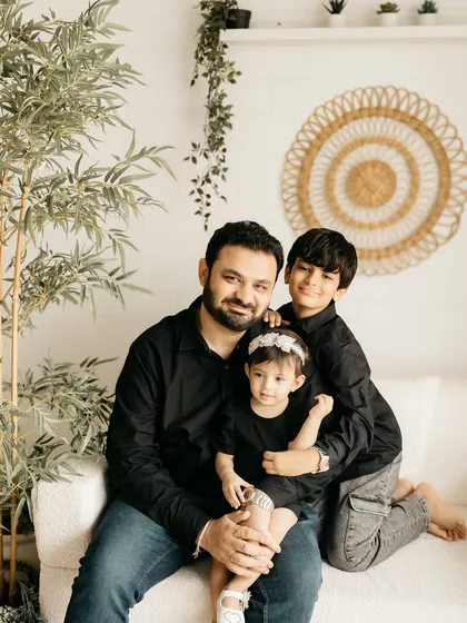 A beautiful family portrait with dad, big brother, and little sister.