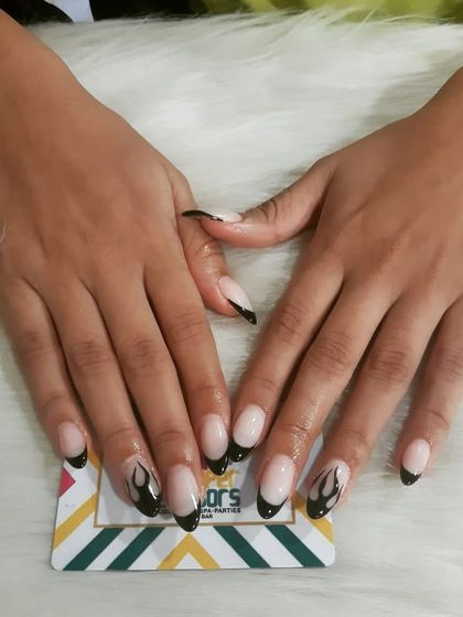 This design combines two trends: the French tip and flame art. I created black flame outlines on the tips of these oval nails for an edgy yet subtle manicure.