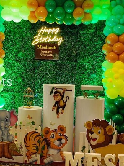 A closer view of the staged jungle theme, showing the character props and grass wall.