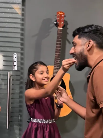 A student shares a celebratory treat with an instructor. We believe in celebrating small wins and creating a family-like atmosphere in our classes.