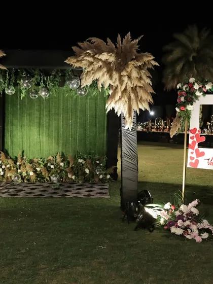 A fun and quirky photo booth setup for a Sangeet, complete with a Valentine's Day frame and pampas grass accents.