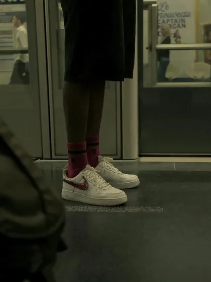 A candid shot from the Paris metro, capturing the custom sneakers in a real-world setting.