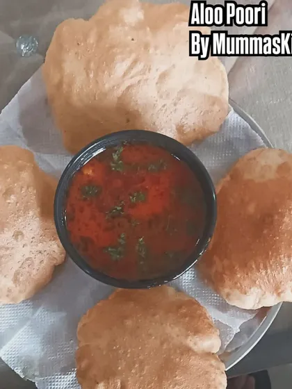 The classic breakfast of Aloo Poori. Fluffy pooris served with a tangy and spicy potato curry.