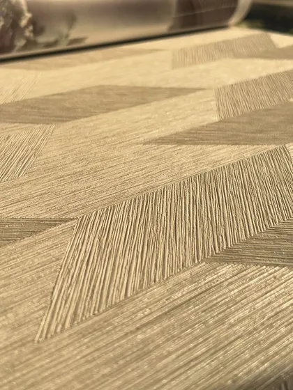 Texture is what sets wallpaper apart from paint. This close-up shows a beautiful beige wallpaper with a woven, geometric texture that adds warmth, depth, and a tactile quality to your walls for a truly refined finish.