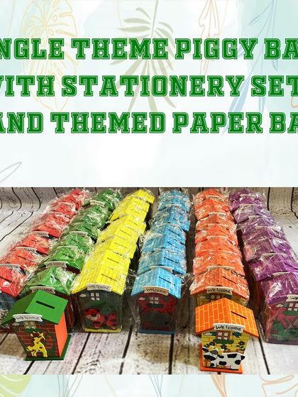 A large batch of house-shaped piggy banks in various colors, ready to be included in the jungle-themed hampers.