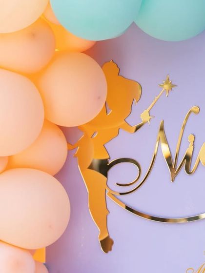 The matching personalized name sign for Nidhi, the other twin, completing the dual-celebration setup.