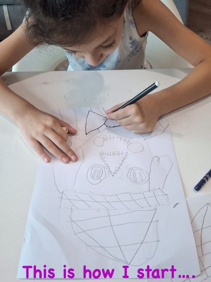 The initial sketch of a scarecrow portrait takes shape. The student focuses on placing the fundamental shapes that will form the character's face and hat.