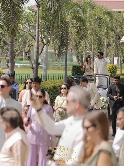 A shot of the baraat procession, with guests capturing the happy moments as the groom arrives.