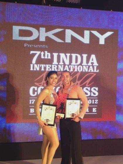 Holding our awards at the 7th India International Salsa Congress in 2012. A proud milestone in our 15-year journey.