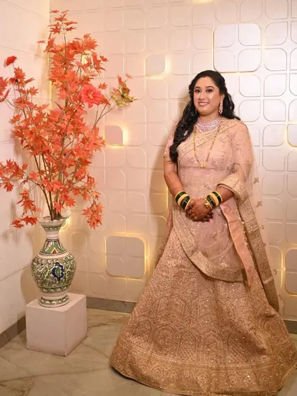 A full-length portrait of the bride in her reception attire. The open hairstyle with soft waves and minimal jewelry creates a look of effortless elegance.