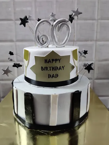 A two-tier 60th birthday cake for a dad. The modern design in black, white, and silver is both masculine and celebratory.