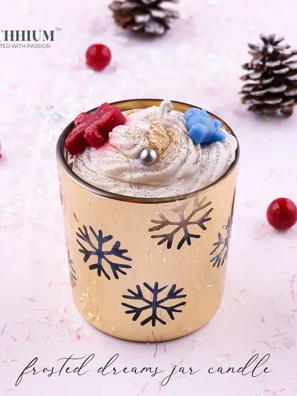 A golden jar with snowflake cutouts, filled with festive red and blue wax stars.