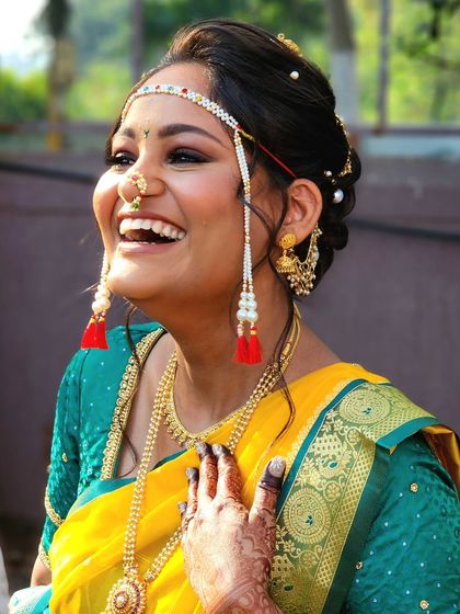 There's nothing more beautiful than a bride's genuine laughter. This candid shot captures the pure joy of her wedding day, enhanced by a classic, radiant makeup look.