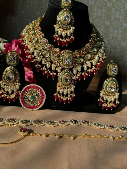 Our multi-coloured Kundan bridal set laid out to show every beautiful piece. The rental includes the necklace, earrings, maang tikka, nath, and a statement ring.