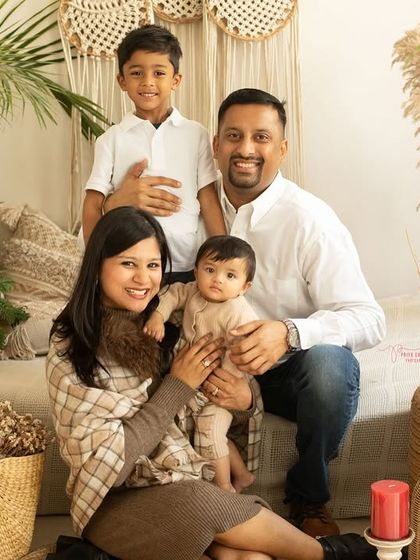 A lovely portrait of a family of four. The studio's boho decor provides a beautiful and neutral backdrop that keeps the focus on the family's connection.