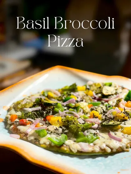 My Basil Broccoli Pizza is a gourmet delight. I use a crisp flatbread base and top it with aromatic basil sauce, a colourful medley of exotic vegetables, and perfectly melted cheese for a fresh take on a classic.