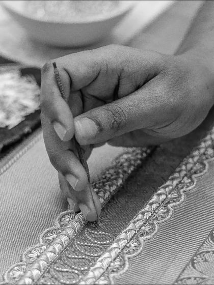 The delicate process of hand-embroidery, where every bead and thread is placed with precision and artistry.