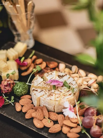 A beautiful Fromage board featuring perfectly ripe brie, nuts, and grapes. This classic combination is a staple of our grazing tables, offering guests a taste of simple luxury.
