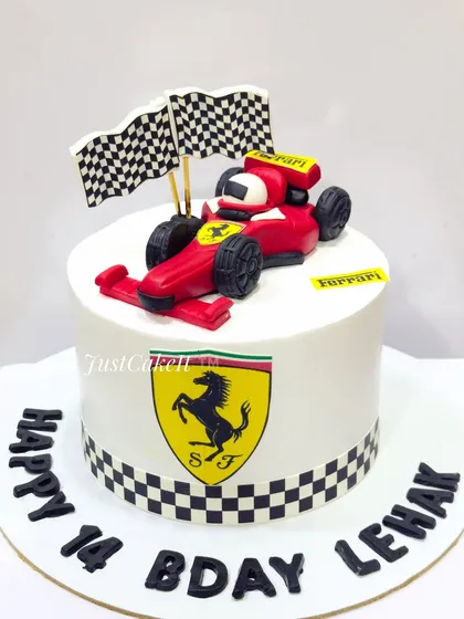 An all-edible Ferrari theme cake for a 14th birthday. The design is sleek and simple, focusing on the iconic logo and a hand-molded F1 car.