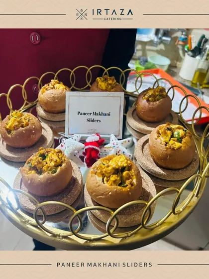 A tray of my Paneer Makhani Sliders being served to guests. The golden tray and festive star decorations show the extra touches I add for special occasions like Christmas parties.