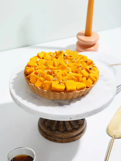 Our mango tart, a perfect circle of sunshine on a plate.