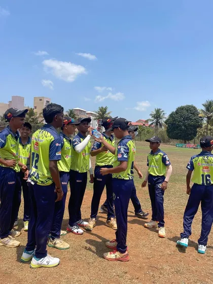 A team discussion during a drinks break on our Goa cricket tour. Staying hydrated and focused is key in tough conditions.