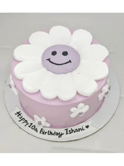 A Korean-style smiley daisy flower cake with a chocolate mousse flavor. This simple and happy design is perfect for a 10th birthday.