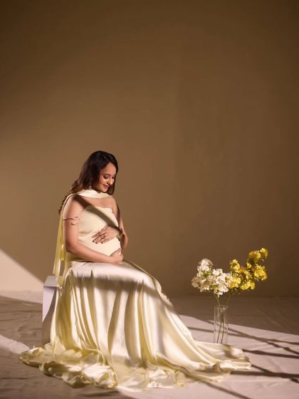 A serene solo portrait using soft, directional light. The way the light falls creates a gentle, peaceful mood, highlighting the beauty and tranquility of pregnancy.