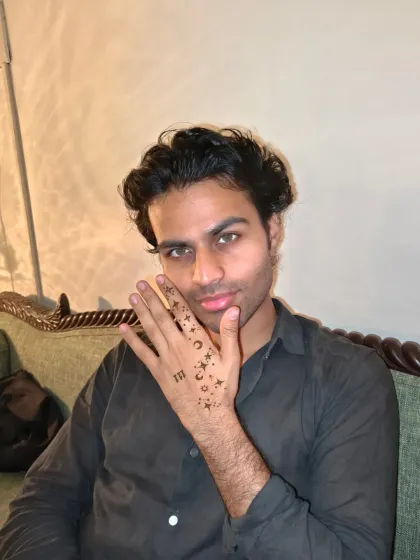 Another pose showcasing this unique and modern henna design for men.