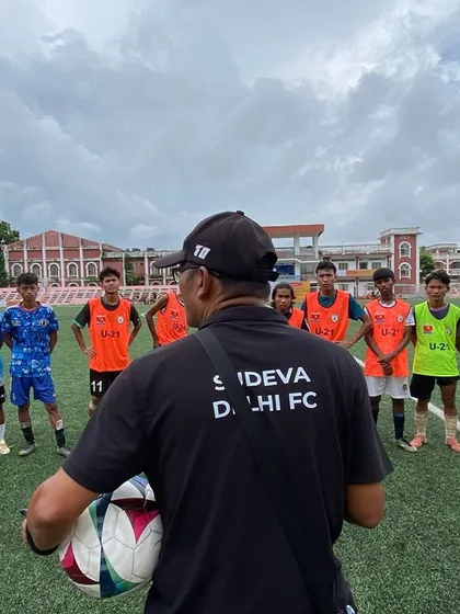A coach speaks to a group of young trialists. We look for players with not just skill, but also the right attitude and discipline.
