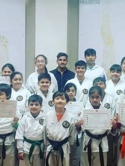 A group photo of our junior and sub-junior students with their certificates. It's great to see students of different belt levels training and growing together.