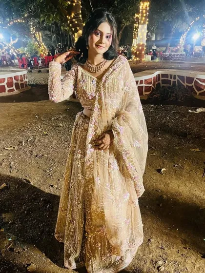 A client looking beautiful at an evening function in our beige and purple floral lehenga.
