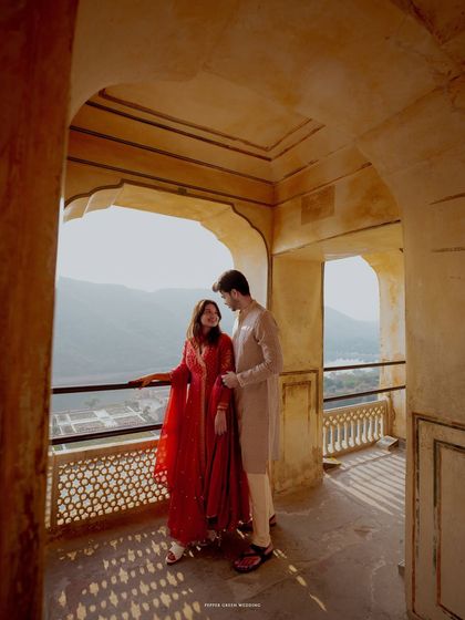 A quiet moment shared on a balcony of Amber Fort, overlooking the majestic landscape. I use natural light and architecture to create timeless and romantic pre-wedding portraits.