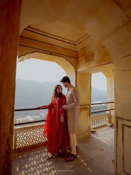 A quiet moment shared on a balcony of Amber Fort, overlooking the majestic landscape. I use natural light and architecture to create timeless and romantic pre-wedding portraits.