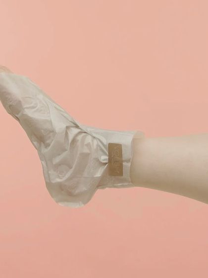 For the ultimate foot care, I use these vegan collagen socks. This photo shows how the sock envelops the foot, delivering a concentrated dose of moisture to heal and soften dry skin.