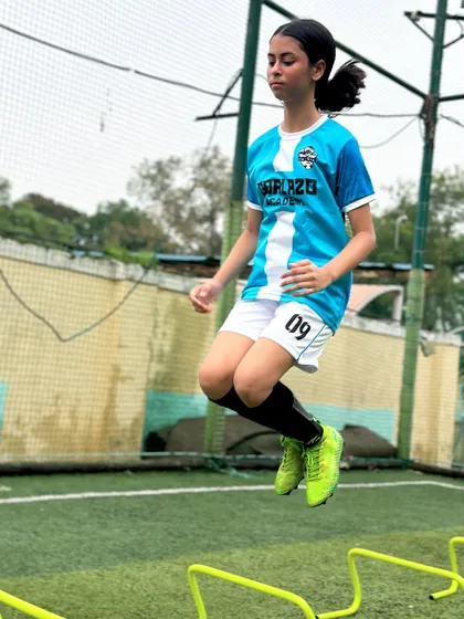 It all starts with the fundamentals. Here, one of our players works on her agility and speed with hurdle drills, building the athletic foundation needed for high-level football.