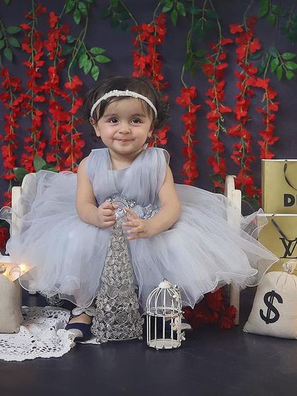 A little fashionista in the making! This unique shopping-themed sitter session is so glamorous, with designer bags, a starry light, and a beautiful grey tulle dress.