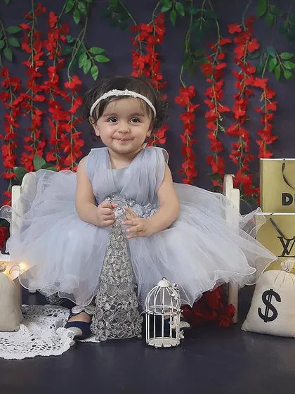 A little fashionista in the making! This unique shopping-themed sitter session is so glamorous, with designer bags, a starry light, and a beautiful grey tulle dress.