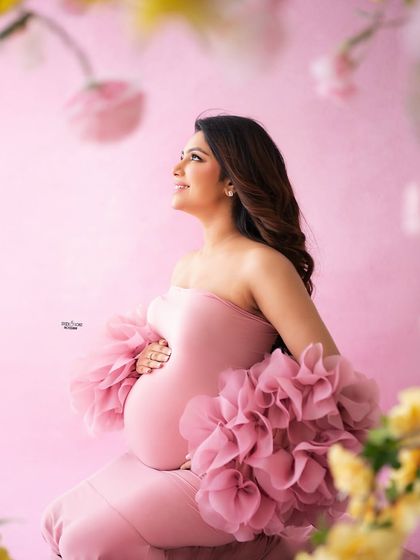 A beautiful close-up profile shot. The soft focus on the flowers in the foreground adds a dreamy, artistic touch.