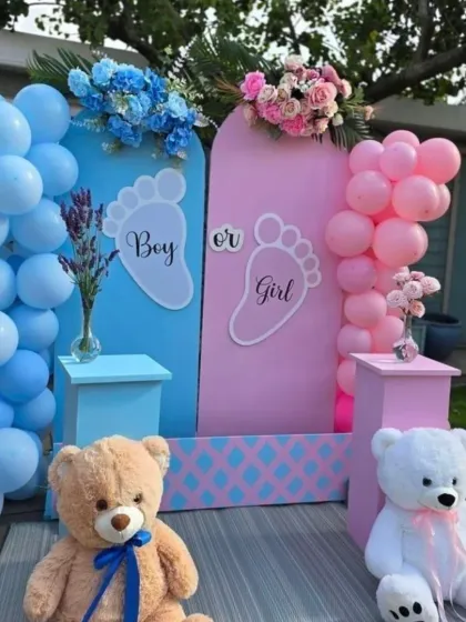 A classic 'Boy or Girl' backdrop perfect for any gender reveal party. This setup uses pink and blue arched panels, matching balloon columns, and cute teddy bears to create a sweet photo opportunity.