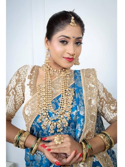 A direct and confident look, showcasing the full beauty of the blue Nauvari and layered jewellery.