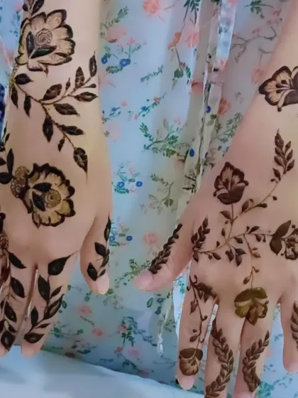 Another view of the delicate floral vine mehendi, showing how it gracefully adorns both hands.