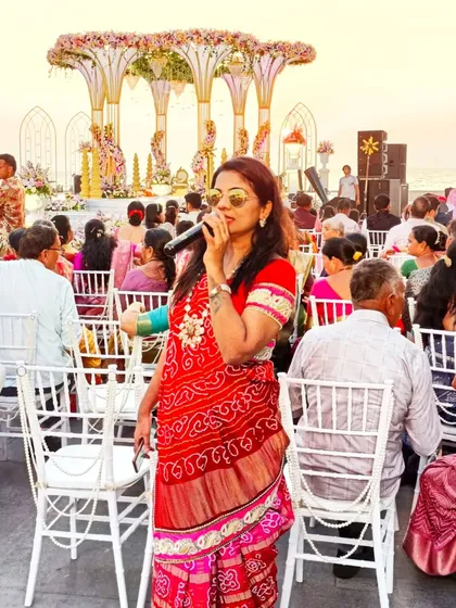 Hosting the beach wedding in Goa, interacting with guests to make them feel part of the ceremony.