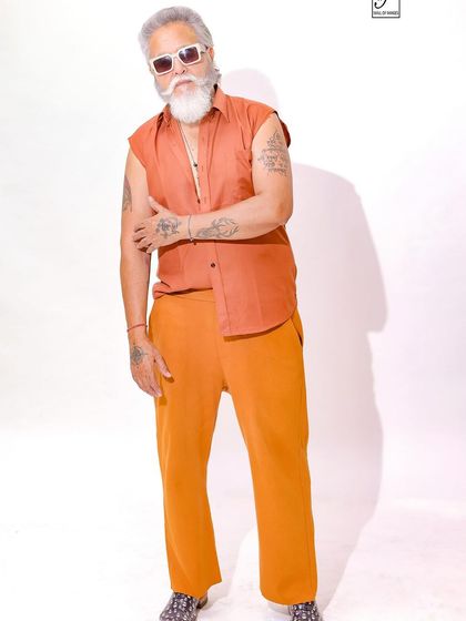 A confident and strong pose, showcasing the model's tattoos and powerful presence.