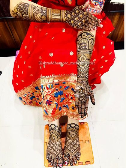 A full bridal look showing both hand and feet mehendi. The feet feature a classic geometric pattern.