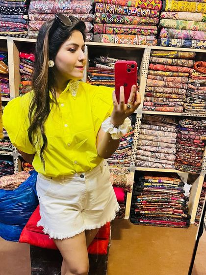 Exploring the colorful markets of Jaisalmer. I paired a bright yellow puff-sleeve top with white denim shorts for a fun and comfortable sightseeing outfit.