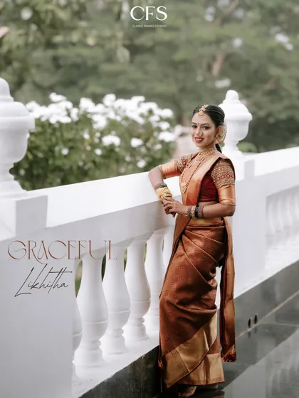 "Graceful Likhitha." A stunning portrait of the bride in her Muhurtham saree, posing elegantly on a white balcony. The soft, natural light enhances her grace.