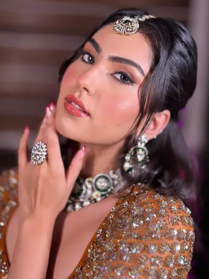 A close-up that shows off the glossy lips and the perfectly blended blush. The skin looks healthy, hydrated, and absolutely glowing.