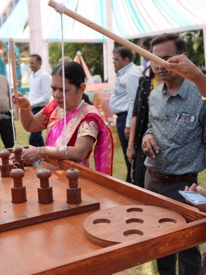 An older guest enjoying a classic ring toss game, proving that my carnival themes are fun for the entire family.