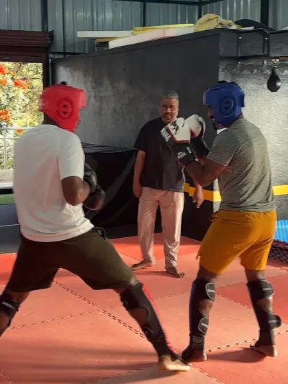 A moment of focus during a supervised sparring session. Students learn to read their opponent and anticipate moves in a controlled environment.